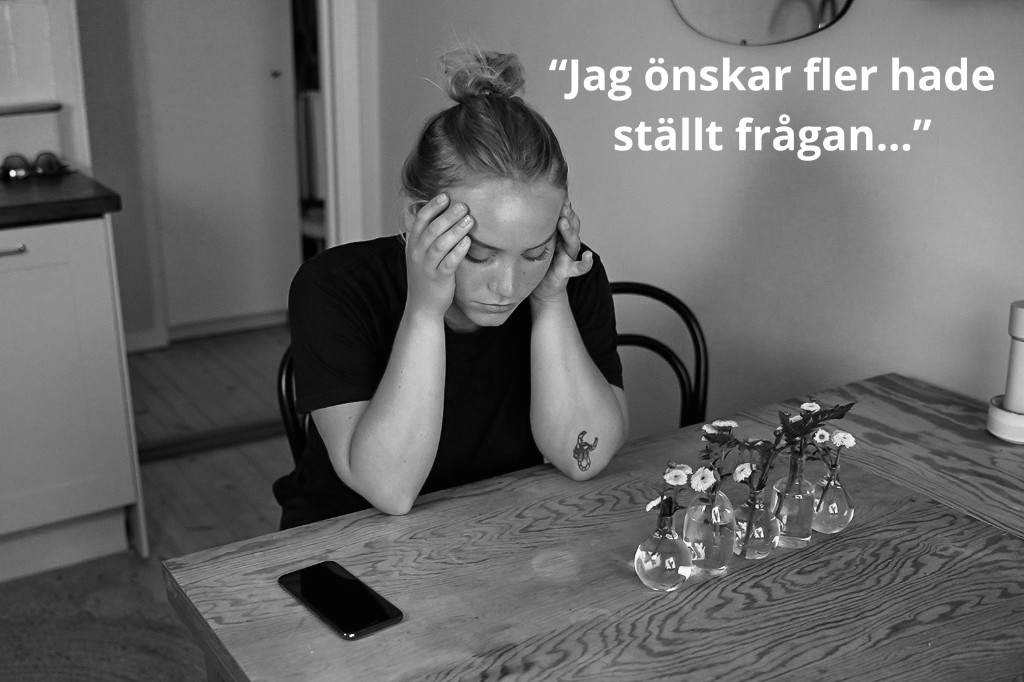 Svartvit bild av en kvinna vid köksbordet med händerna mot tinningarna. Texten lyder: Jag önskar fler hade ställt frågan...
